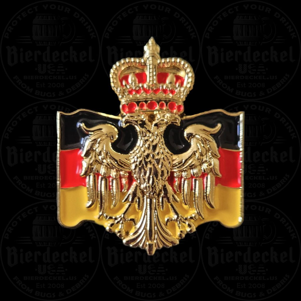 German Eagle Heritage Hat Pin Celebrate your European roots and elevate your traditional festival attire with our striking German Eagle Heritage Hat Pin. Whether you are attending a massive Oktoberfest celebration, enjoying a local heritage festival, or adding a patriotic touch to your favorite Tyrolean hat, this accessory perfectly balances historic heraldry with modern national pride. Designed with a high-contrast, "Old World" aesthetic, this premium lapel pin is a true standout piece. The centerpiece of the design features a highly detailed, golden German eagle with deep relief sculpting that catches the light beautifully. The eagle is elegantly topped with a classic royal crown, finished with brilliant red enamel accents. Serving as a striking backdrop to the golden eagle is a beautifully sculpted, waving flag displaying the bold Black, Red, and Gold colors of modern Germany (Deutschlandfahne). Crafted from heavy-duty, brilliant gold-tone metal, this festival pin is built to last through years of celebrations while maintaining its vintage, premium look. Key Features & Specifications Iconic Heraldry: Features a deeply sculpted, golden German eagle topped with a detailed, red-accented royal crown. Patriotic Backdrop: The eagle rests against a beautifully shaped, waving banner featuring the modern black, red, and gold stripes of the German flag. Premium Materials: Struck in high-quality gold-tone metal with vibrant, high-contrast enamel details. Ideal Dimensions: Measuring approximately 1" x 1.25", it offers a bold pop of color in a compact footprint, making it perfect for layering with other pins. Secure Fastening: Equipped with a sturdy, reliable backing to keep your pin firmly in place while you dance to the polka band and celebrate. How to Style Your Heritage Hat Pin In traditional Bavarian and Tyrolean culture, hat pins, crests, and boar hair brushes are worn on the left side of the hat. The compact, horizontal shape of this German Eagle Heritage Hat Pin makes it an excellent layering piece to tuck beneath larger vintage hiking pins or Edelweiss flowers. Not wearing a hat to the festival? This versatile, high-quality crest looks incredibly sharp pinned to the lapel of a traditional Trachten jacket, a canvas tote, or a leather festival harness. Authentic Festival Gear from Bierdeckel USA When it comes to authentic festival wear, the details make all the difference. This piece was specifically designed to blend traditional German heraldry with striking modern pride. Add this classic golden crest to your collection today and wear your heritage with pride!