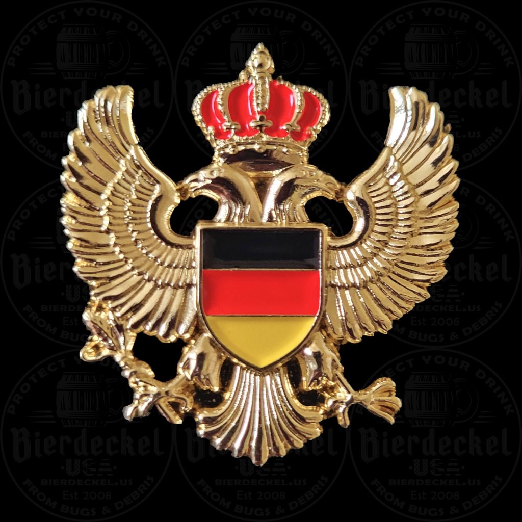 Imperial Eagle Hat Pin Celebrate your deep German roots and elevate your festival attire with our striking Imperial Eagle Hat Pin. Whether you are attending a massive Oktoberfest celebration, walking the grounds of a local heritage festival, or adding a regal touch to your favorite Tyrolean hat, this accessory perfectly captures the majesty of European history. Designed with a high-contrast, "Old World" aesthetic, this premium lapel pin is a true standout piece. The design features a magnificent double-headed golden eagle—a historic symbol of imperial strength and endurance—grasping a traditional scepter and orb. The eagle is elegantly topped with a detailed royal crown finished in brilliant red enamel. At the very center of the bird’s chest rests a bold, classic shield displaying the modern Black, Red, and Gold colors of the German flag (Deutschlandfahne). Crafted from heavy-duty, brilliant gold-tone metal, this festival pin is built to last through years of celebrations while maintaining its vintage, premium look. Key Features & Specifications Iconic Heraldry: Features a historic double-headed imperial eagle holding a scepter and orb, topped with a royal crown. Patriotic Details: The center shield proudly displays the modern black, red, and gold stripes of the German flag. Premium Materials: Struck in high-quality gold-tone metal with vibrant red, black, and yellow enamel accents. Ideal Dimensions: Measuring approximately 1.5" x 1.5", it offers a bold, symmetrical presence without weighing down your headwear. Secure Fastening: Equipped with a sturdy, reliable backing to keep your pin firmly in place while you dance to the polka band and celebrate. How to Style Your Heritage Hat Pin In traditional Bavarian and Tyrolean culture, hat pins, crests, and boar hair brushes are worn on the left side of the hat. The balanced, regal shape of this Imperial Eagle Hat Pin makes it the perfect centerpiece to layer alongside other vintage hiking pins, Edelweiss flowers, or accordion charms. Not wearing a hat to the festival? This versatile, high-quality crest looks incredibly sharp pinned to the lapel of a traditional Trachten jacket, a canvas bag, or a leather festival harness. Authentic Festival Gear from Bierdeckel USA When it comes to authentic festival wear, the details make all the difference. This piece was specifically designed to blend traditional German heraldry with striking modern pride. Add this classic golden crest to your collection today and wear your heritage with pride!